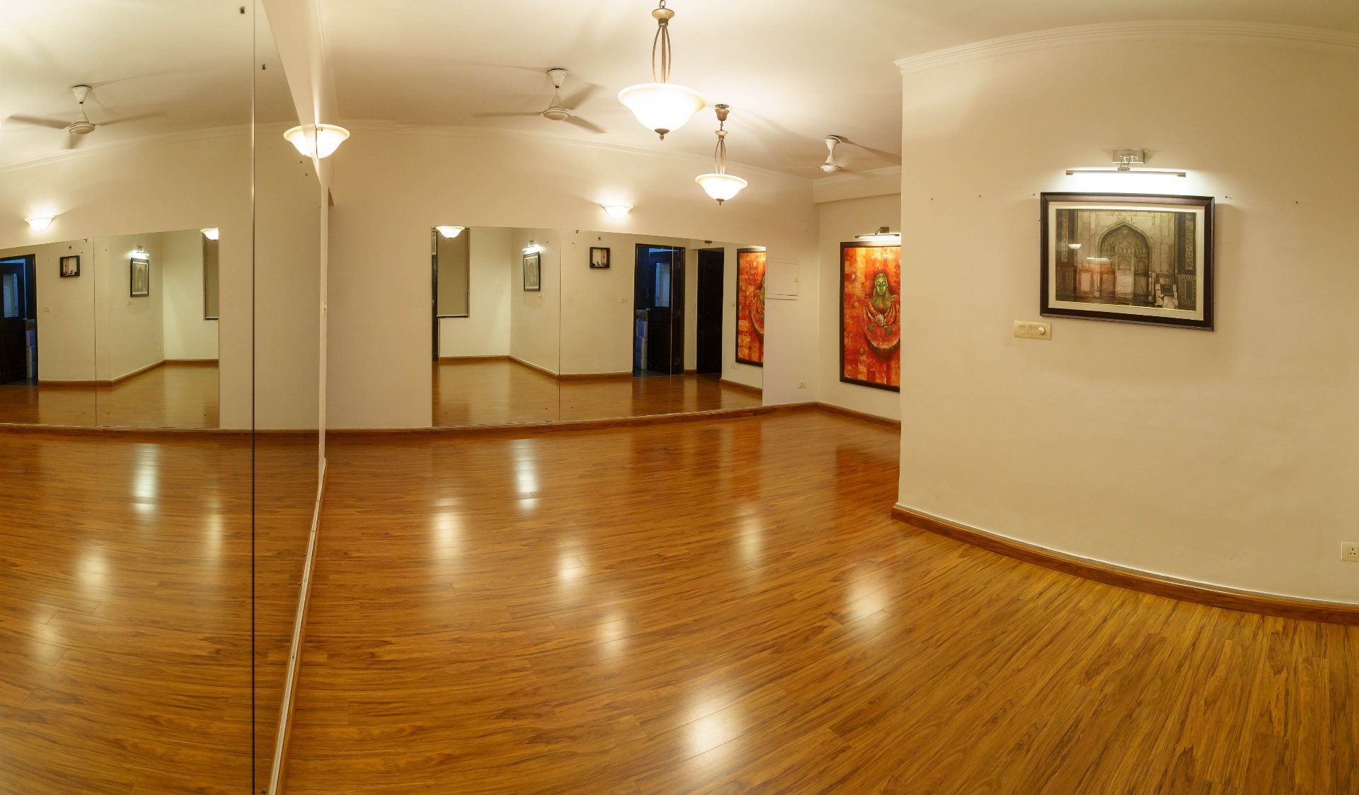 Mirrored practice hall, warm wooden floor